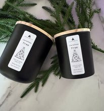 Load image into Gallery viewer, Christmas Tree soy candle with lemon, cedar, and fir notes creating a fresh, evergreen holiday aroma.
